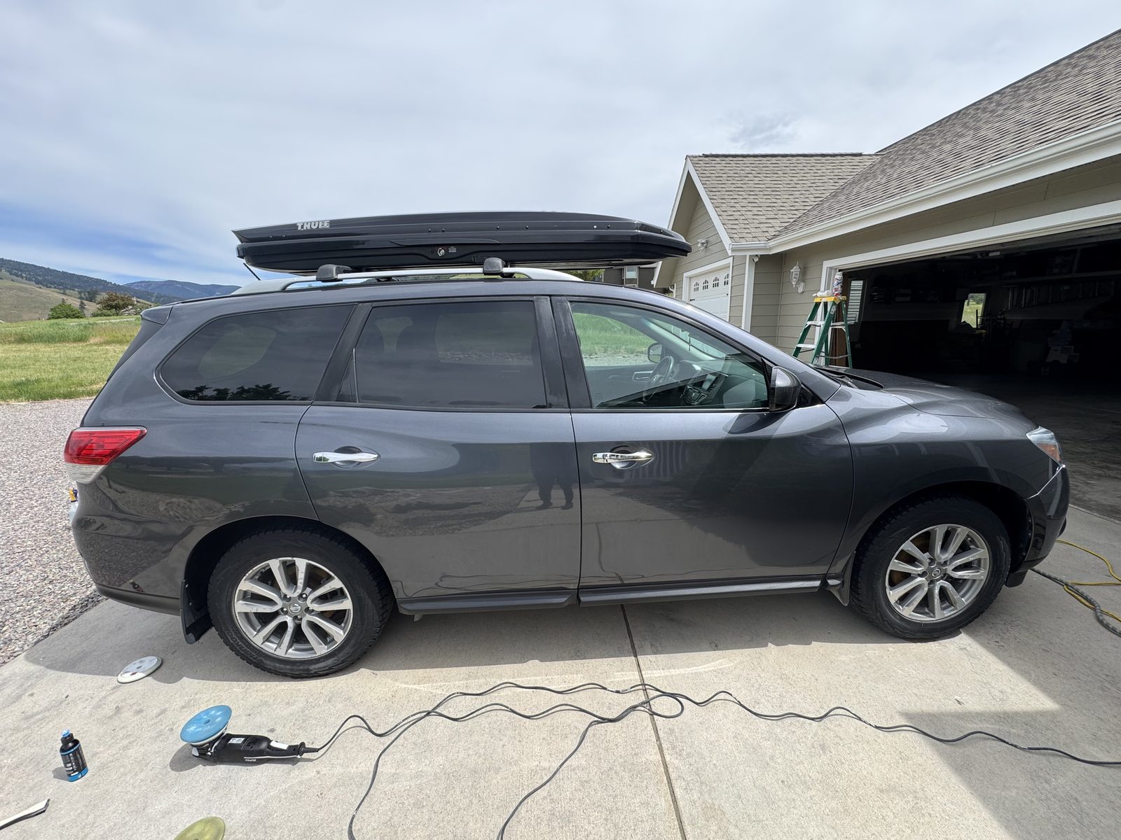 Detailed Nissan Pathfinder gleaming after a full exterior detail by Herd Detailing, Missoula Montana mountains in the background