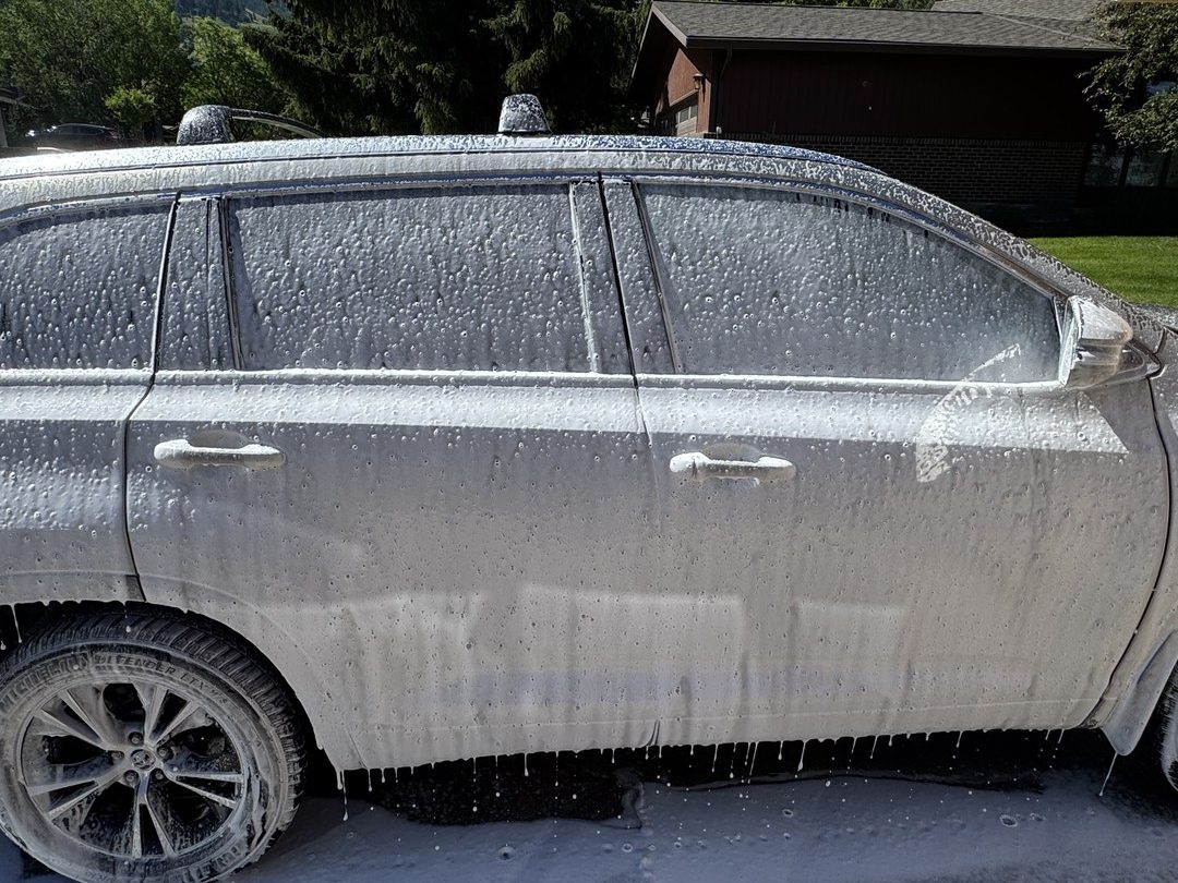 SUV covered in thick foam during an exterior wash by Herd Detailing in Missoula