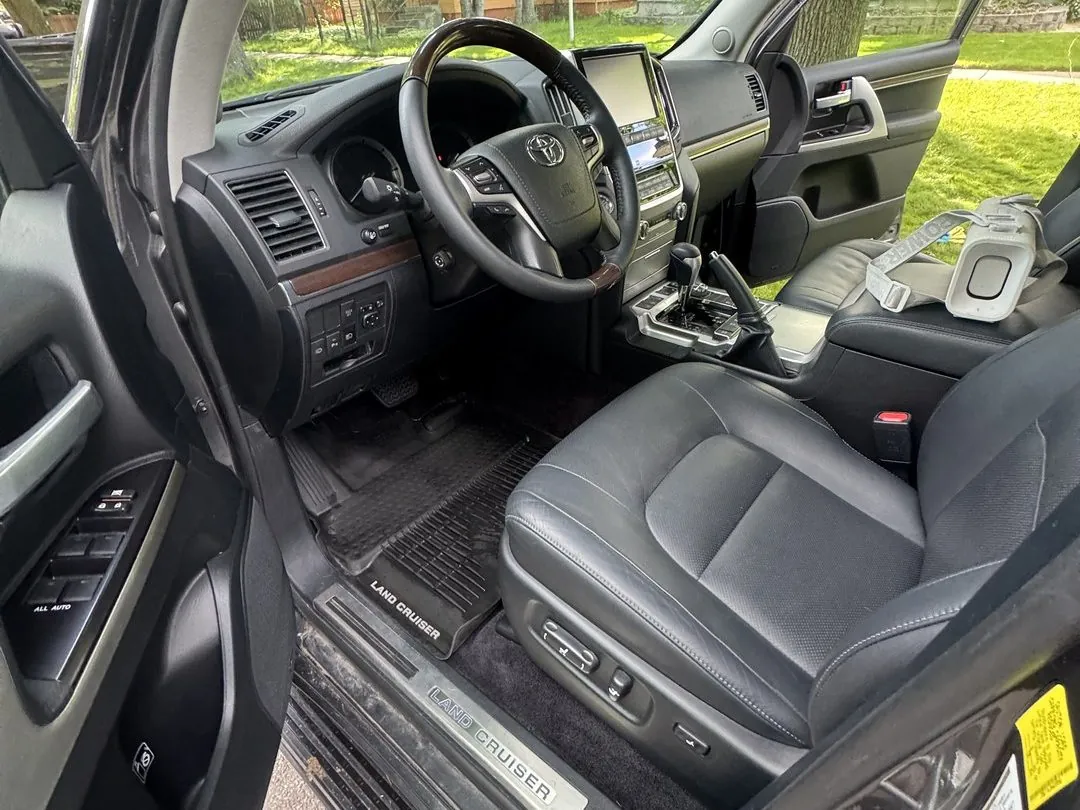 Clean black leather front seats and dashboard in a Toyota Land Cruiser detailed in Missoula